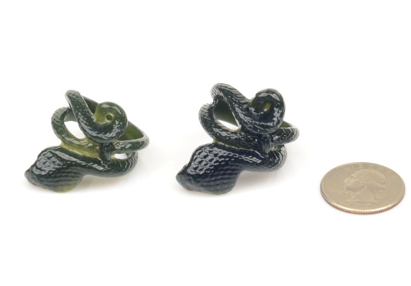 Cobra-shaped nephrite jade thumb rings, alternate angle, studio lighting