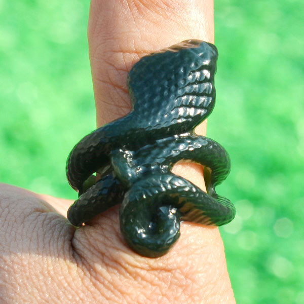 Single carved jade cobra thumb ring in natural light