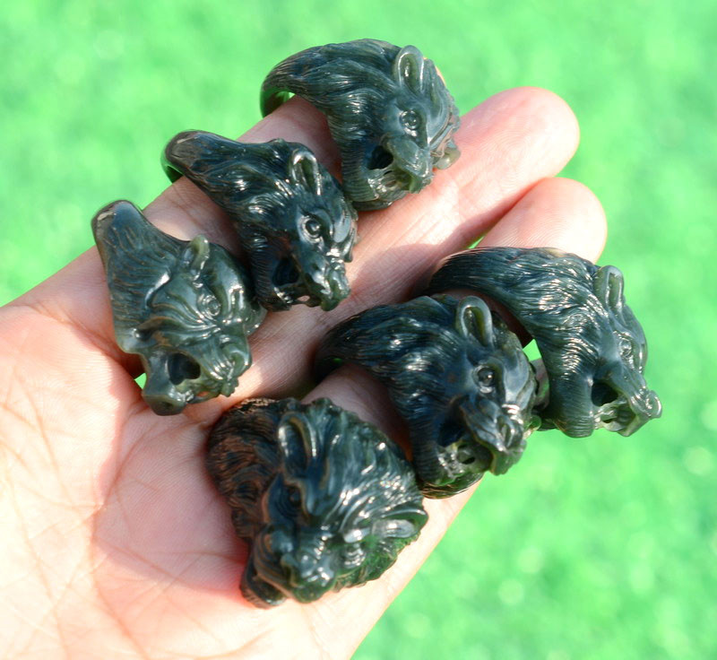 Group view of jade beast head thumb rings from another angle in natural light