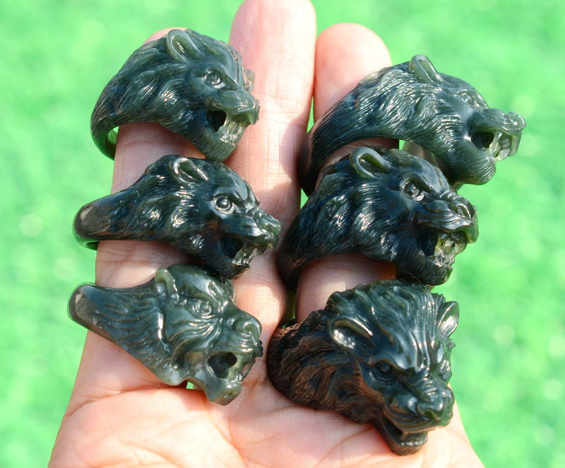 Group of carved jade beast-head thumb rings in natural light