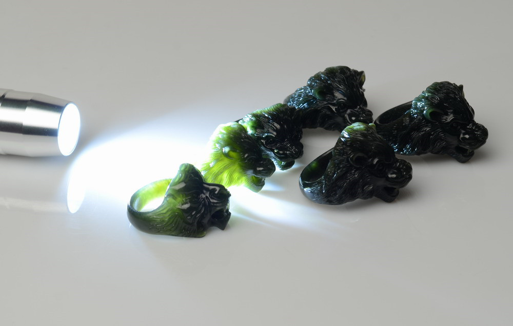 Nephrite jade thumb rings showing translucency under strong light