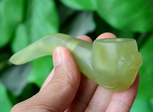 Image of a collection of natural serpentine smoking pipes and tobacco pipes.