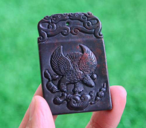 Natural Cinnabar Crystal Eagle Pendants in studio light