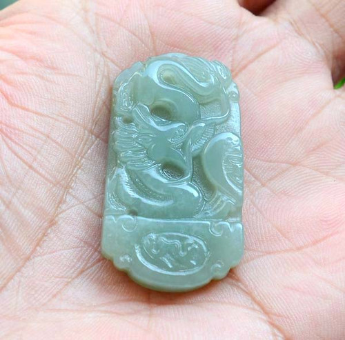 Collection of all jade dragon and phoenix pendants under lighting