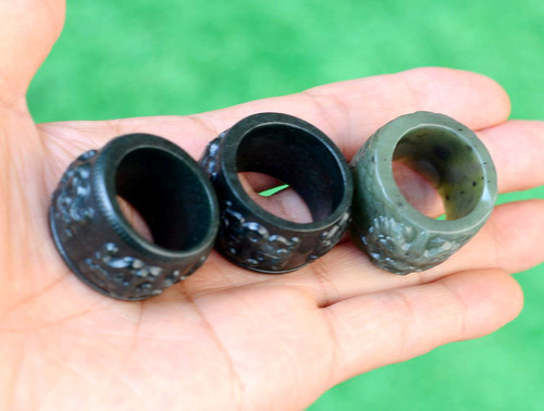 Carved nephrite jade thumb rings with beast and dragon motifs, alternate angle