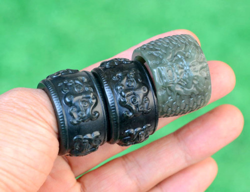 Three carved jade banzhi rings photographed in natural light