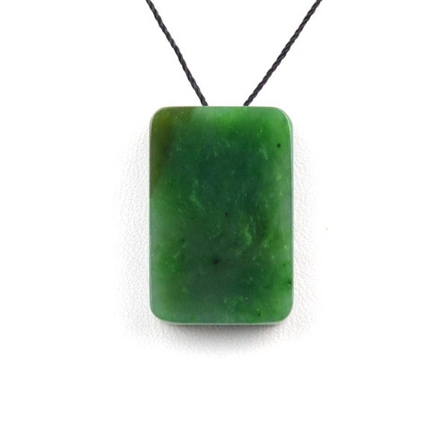 G026541A Single Variant A green Canadian jade rectangular pendant with natural black chromium spots on cord.