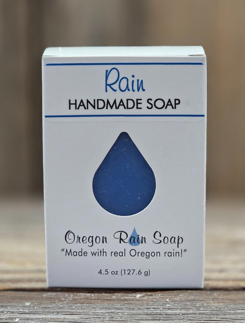 Boxed Rain Handmade Soap with a raindrop cutout to view the blue color and the fresh clean scent of this soap.