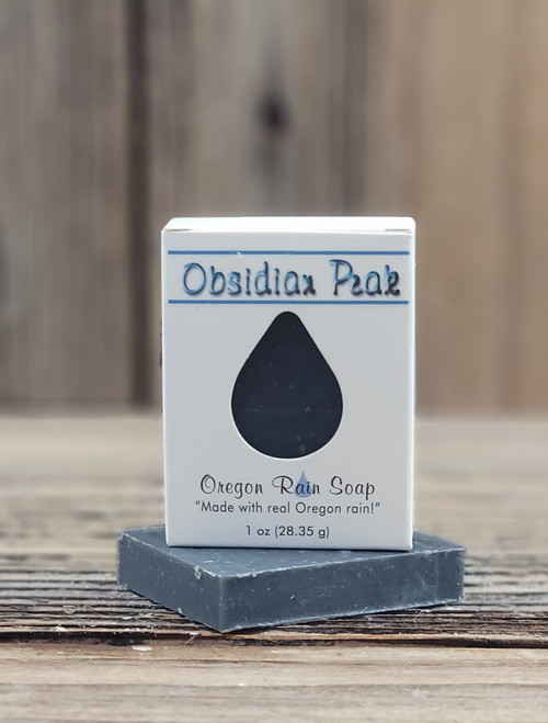 Boxed 1 oz. Obsidian Peak Handmade Soap bar with a raindrop cutout to smell and view this manly smelling soap. Great size for guests or travel.