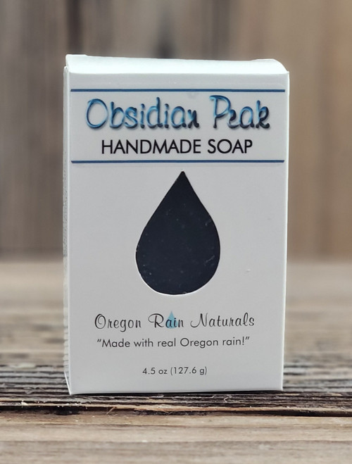 Boxed Obsidian Peak Handmade 4.5 oz Soap bar with a raindrop cutout to smell and view this manly scent. "Made with real Oregon rain!"