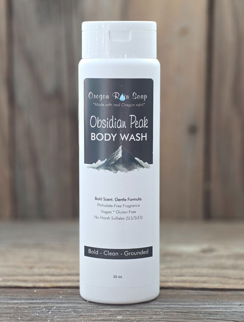 The front of a tall white 16 oz squeeze bottle featuring Obsidian Peak Body Wash that is perfect for daily use.