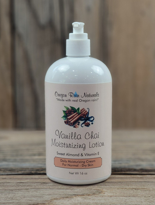 16 oz pump bottle of Vanilla Chai Moisturizing Lotion enriched with nourishing oils, displayed on a wooden surface.
