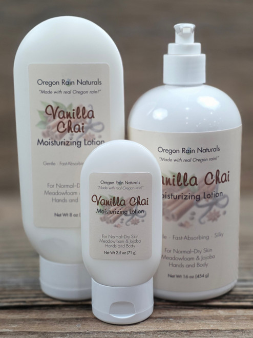 Vanilla Chai Moisturizing Lotion in three sizes—2.5 oz, 8 oz, and 16 oz bottles displayed on a wooden background.