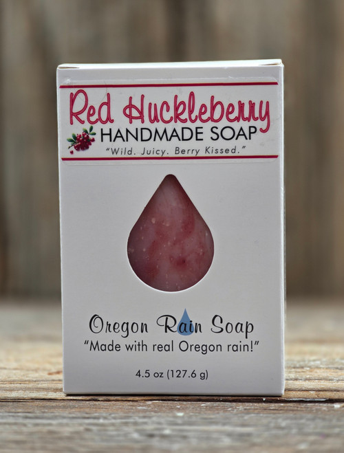 White boxed Red Huckleberry Handmade 4.5 oz Bar Soap with a raindrop cutout for viewing the red swirls of the soap bar and smell the sweet smelling soap.
