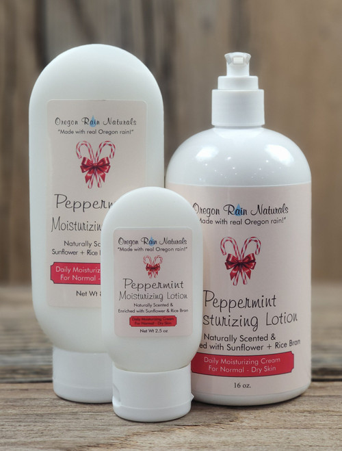 Peppermint Moisturizing Lotion in three sizes—2.5 oz, 8 oz, and 16 oz bottles displayed on a wooden background.