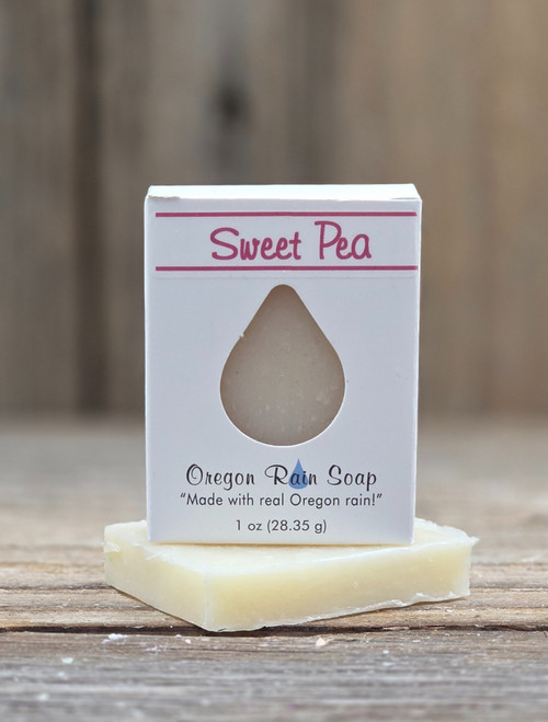 White boxed Sweet Pea Ultra Hydration Handmade Soap with an open raindrop cutout to smell this delicate, sweet floral scent and to see the soap.