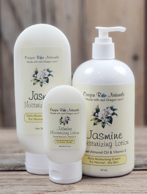 Jasmine Moisturizing Lotion in three sizes—2.5 oz, 8 oz, and 16 oz bottles displayed on a wooden background.