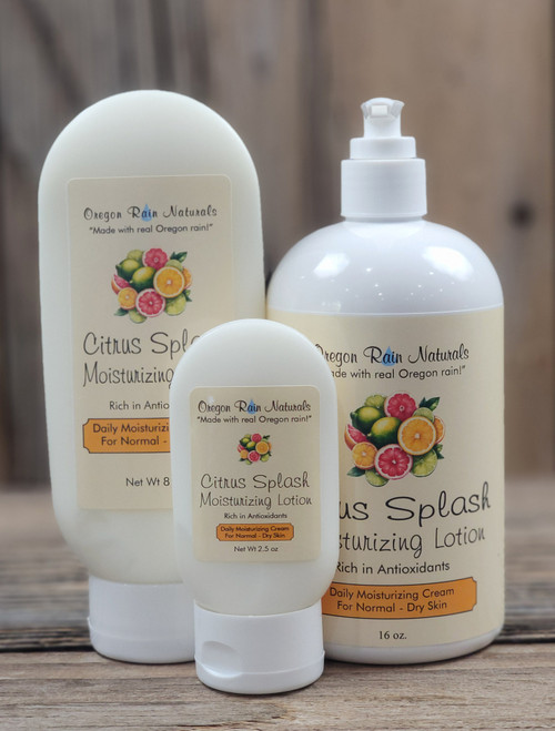 itrus Splash Moisturizing Lotion in three sizes—2.5 oz, 8 oz, and 16 oz bottles displayed on a wooden background.