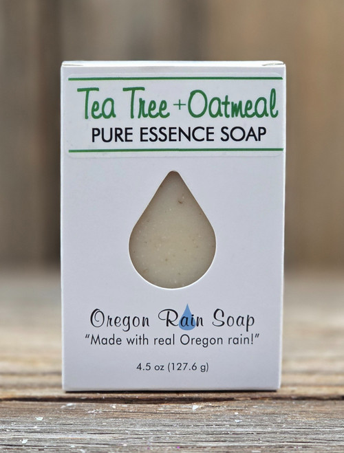 Boxed Tea Tree + Oatmeal Pure Essence Handmade 4.5 oz Full Bar with a cutout raindrop for viewing and smelling this naturally scented soap.