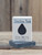 Boxed 1 oz. Obsidian Peak Handmade Soap bar with a raindrop cutout to smell and view this manly smelling soap. Great size for guests or travel.