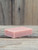 Unboxed Pink Grapefruit Handmade Soap bar sitting on a slab of barn wood.