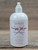 16 oz pump bottle of Oregon Rain Naturals Dragon Slayer Moisturizing Lotion with Meadowfoam and Jojoba oils on a wooden surface.
