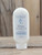 8 oz bottle of Rain Moisturizing Lotion with fresh, clean rain graphics on the label, shown on a wooden background.