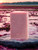 Unboxed Cranberry Handmade 4.5 oz Bar Soap showing the soaps pretty cranberry color with a cranberry bog in the background.