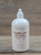 16 oz pump bottle of Vanilla Chai Moisturizing Lotion enriched with nourishing oils, displayed on a wooden surface.