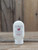 2.5 oz bottle of Red Huckleberry Moisturizing Lotion on a wooden surface, featuring red huckleberry imagery on the label.