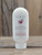 8 oz bottle of Red Huckleberry Moisturizing Lotion with berry graphics on the label, shown on a wooden background.