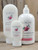 Red Huckleberry Moisturizing Lotion in three sizes—2.5 oz, 8 oz, and 16 oz bottles displayed on a wooden background.