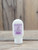 2.5 oz bottle of Lavender Moisturizing Lotion on a wooden surface, featuring lavender imagery on the label.