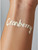 The word "Cranberry" written on a forearm with our thick, creamy lotion