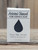 4.5 oz Activated Charcoal Pure Essence Soap in a white box with a raindrop cutout showing the dark charcoal bar, displayed on a wooden surface.