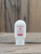 2.5 oz bottle of Peppermint Moisturizing Lotion on a wooden surface, featuring peppermint imagery on the label.