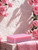 An unboxed pink Portland Rose soap with pink roses around.
