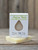 1 oz Anjou Pear Handmade Soap in a white box with a raindrop cutout showing the light pear‑colored bar, displayed on a wooden surface.