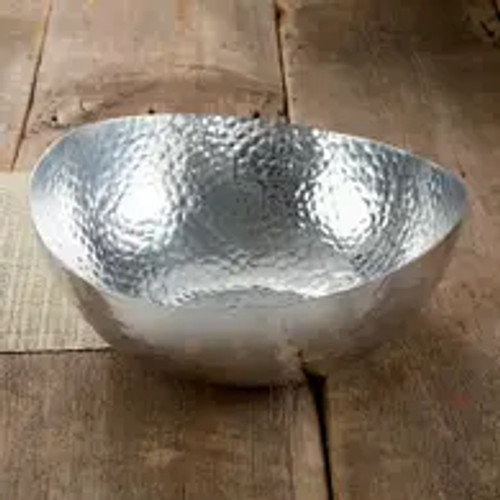 The Hammered Oblong Bowl is a stunning addition to your home serverware collection. Crafted from high-quality aluminum, this large bowl boasts a sleek silver finish that adds a touch of elegance to any table setting. The hammered texture on the surface of the bowl creates a unique and eye-catching design, making it a perfect centerpiece for your dining table or buffet. With a generous capacity of 4 quarts, this bowl is ideal for serving salads, pasta, or any other delicious dish at your next gathering. Whether you're hosting a formal dinner party or a casual family meal, the Hammered Oblong Bowl is sure to impress your guests with its stylish and functional design.
