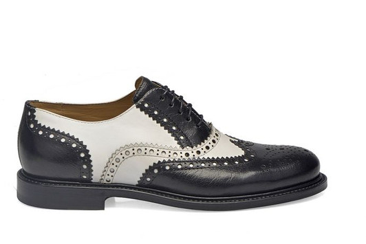 Goodyear Welted men's brogues in high-contrast black and white leather showing the frame-sewn sole.