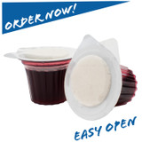 Elements Communion prefilled cup with Concord grape juice, lid partially opened