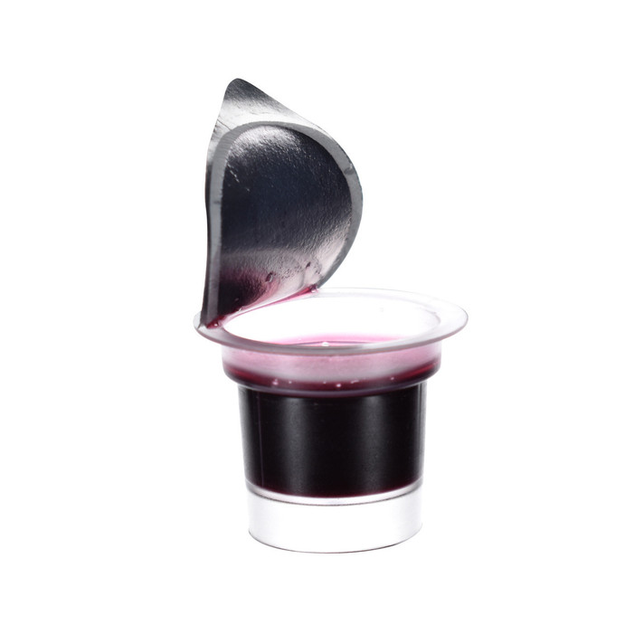 Sealed gluten-free communion cup showing visible Concord grape juice