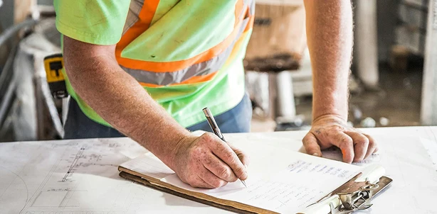 Team member reviewing project plans and lighting specifications
