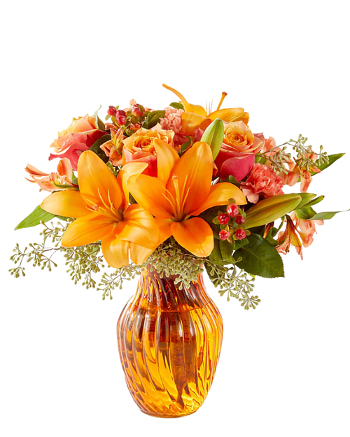 Lily Orchard bouquet with orange lilies, roses, and seeded eucalyptus in a matching orange vase at Arizona Florist in Phoenix AZ