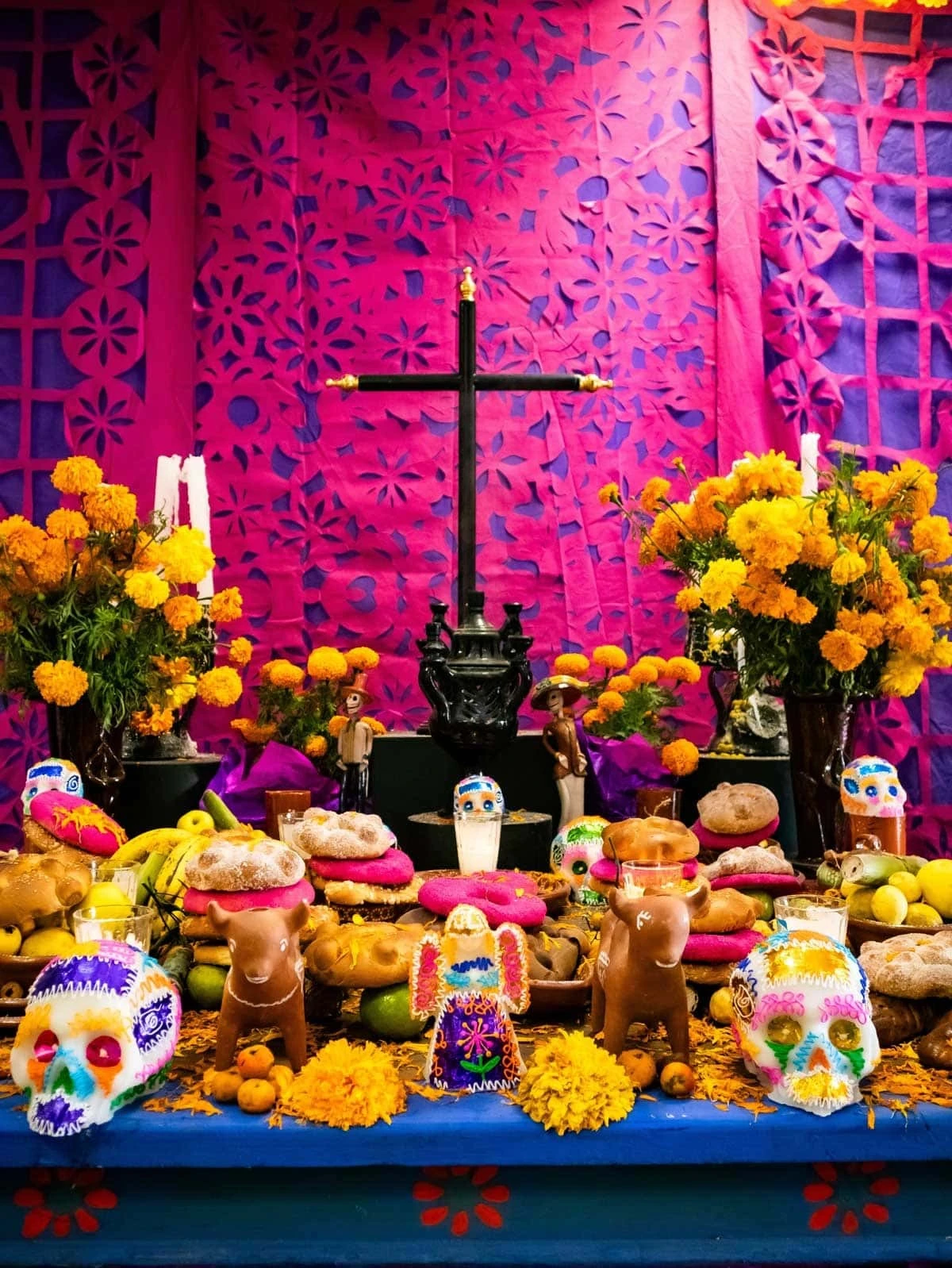 Día de los Muertos ofrenda decorated with marigolds, candles and traditional elements