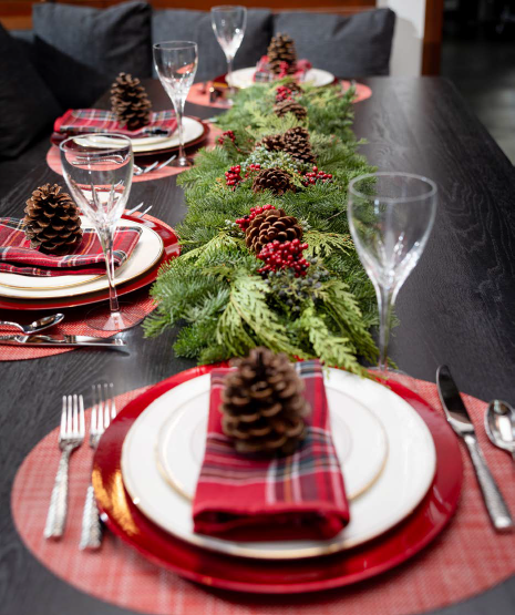 Fresh Christmas evergreen garland decorating a holiday table