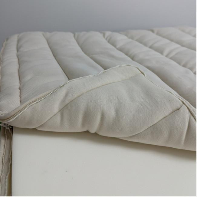 FoamOrder Organic Pillow Top Mattress Case, close-up view of a soft, quilted mattress cover with a zipper, designed to protect and enhance a mattress.