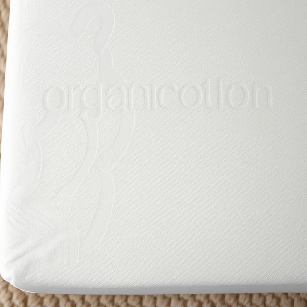 Heavy Organic Cotton Mattress Cover, close-up of white mattress cover with textured pattern and embroidered logo.
