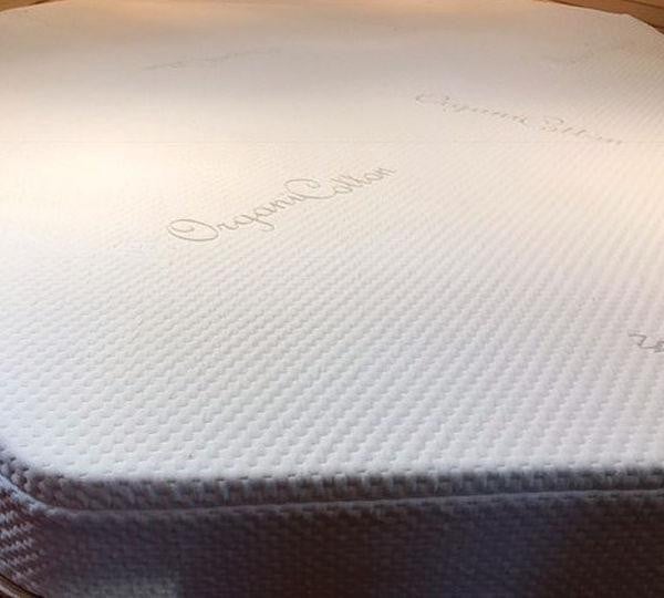 Organic Cotton–Poly Blend (40/60) Zippered Case, close-up view of the textured white fabric with a subtle embroidered logo.