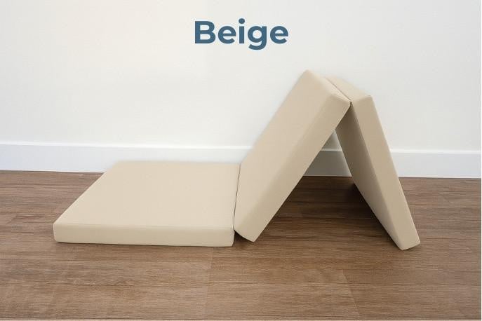 Tri-Fold Foam Mattress, beige foldable foam mattress in a partially folded position on wooden floor against a white wall with the word 'Beige' written above.